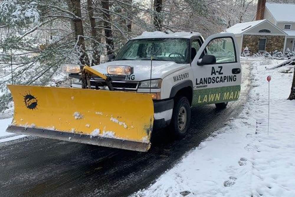A-Z Landscaping pick up truck with a snow plowing