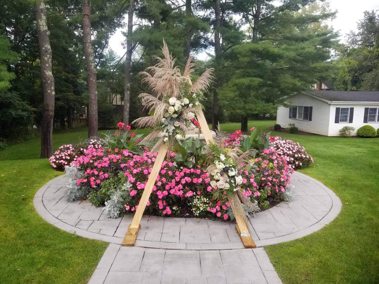 A flowers and shrub in the walkway