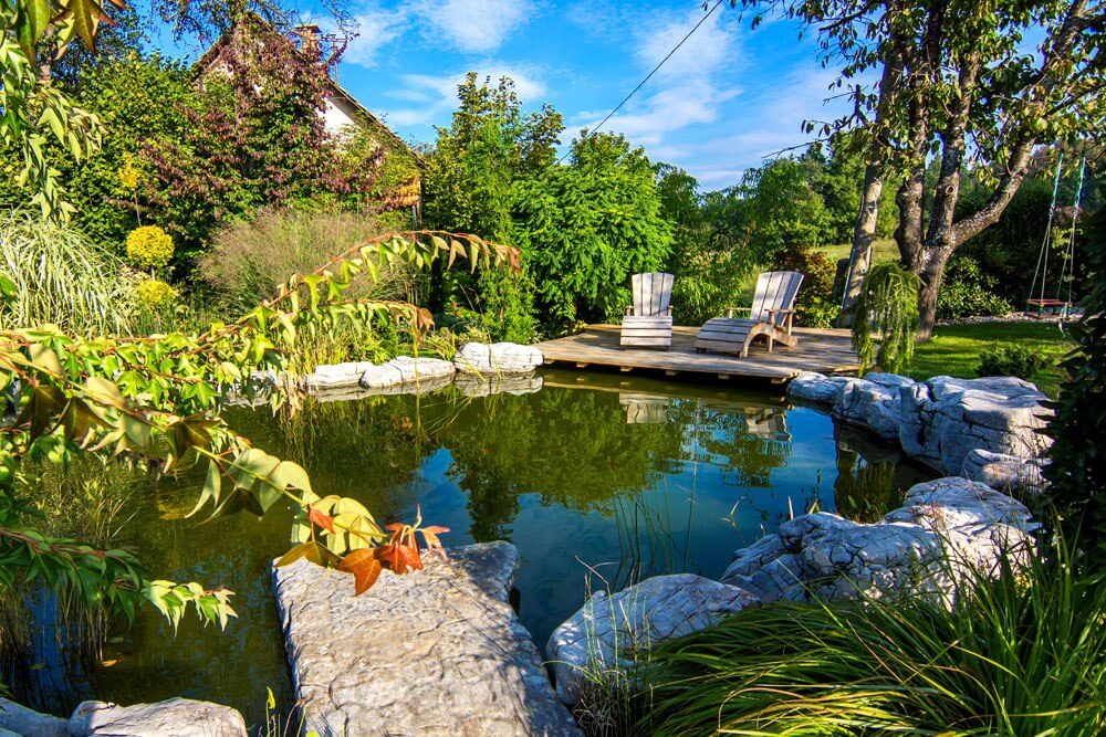 Two chairs on a deck on a garden pond | A-Z Landscaping